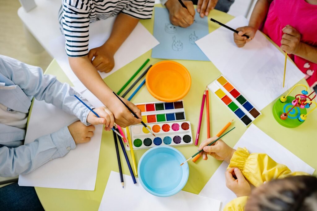 Group of children doing painting with water color
