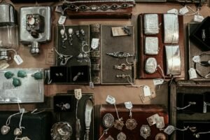 A curated selection of vintage and antique items on a display, including jewelry, books, and decorative pieces.